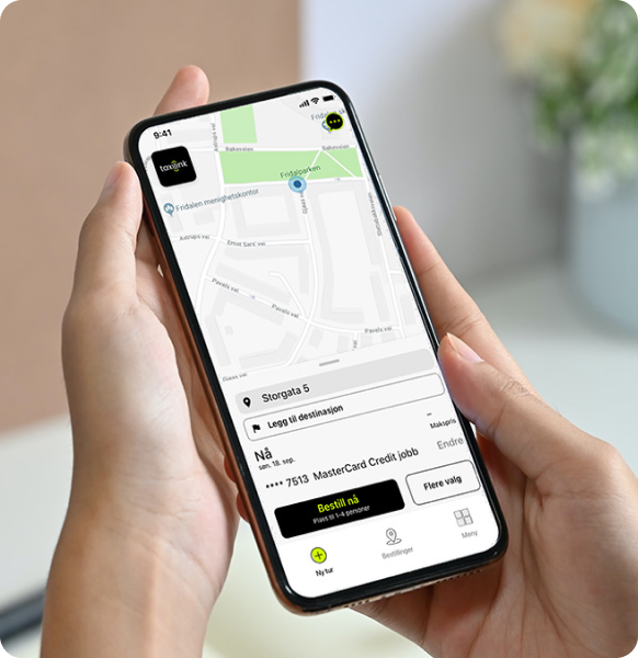 Hands holding phone showing taxilink app