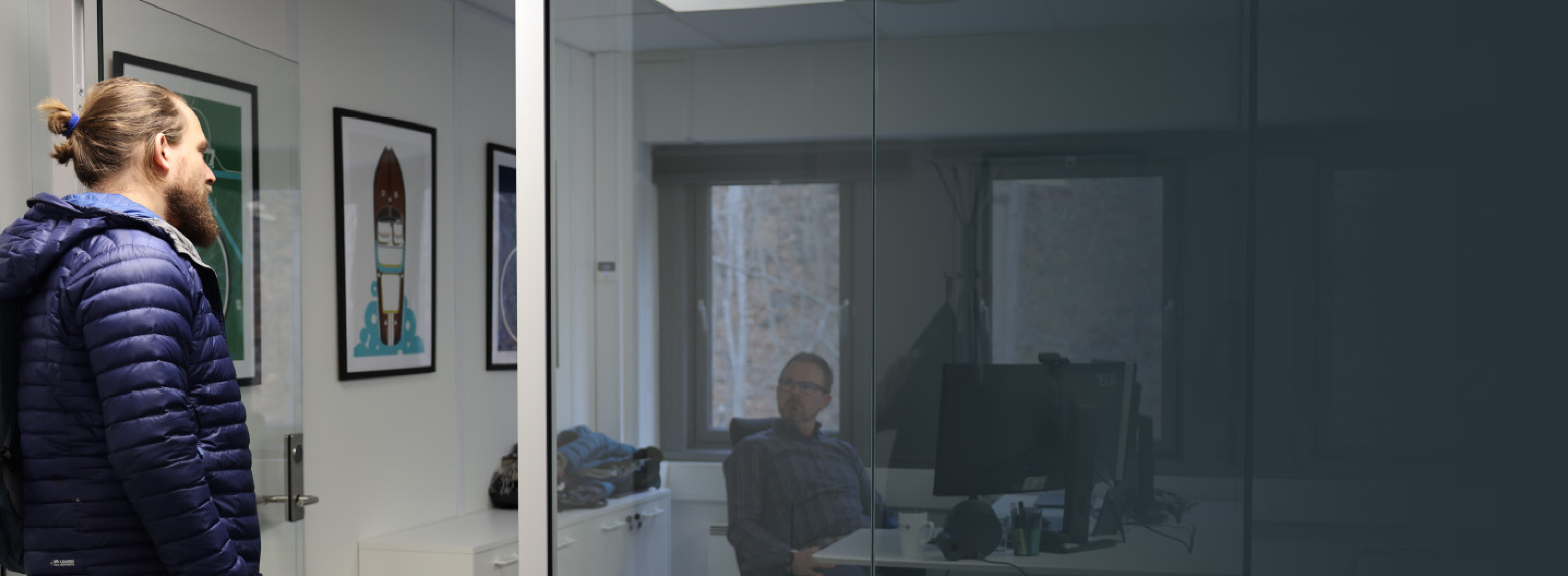 Two men talking to each other in an office